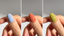 three images showing thumbs painted three different shades. left to right is blue, orange, green