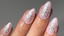 shot of hand with short almond nails - nails are done with light pink base and a sparkly starfish painted on each one
