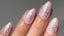 shot of hand with short almond nails - nails are done with light pink base and a sparkly starfish painted on each one