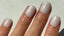 Short square nails painted with pearly white shimmer gel polish, featuring 14 Day Mani's HEMA-free formula – soft, elegant manicure in natural light