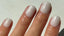 Short square nails painted with pearly white shimmer gel polish, featuring 14 Day Mani's HEMA-free formula – soft, elegant manicure in natural light