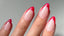 Close-up of hands with red French tip gel nails