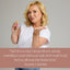 Woman holding a pink nail gloss with a quote from Suzanne Cummins on a gray background