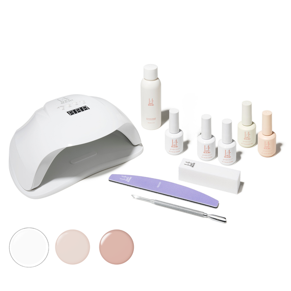 Gel Polish Kit with lamp, bottles, and tools on a white background